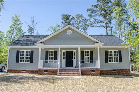 ranch house with gray siding & white metal roofing|ranch style homes exterior.